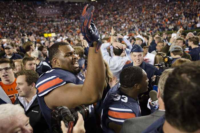 Auburn offensive lineman Calvin Ashley (70) celebrates after the Iron Bowl NCAA football game between Auburn and Alabama on Saturday, Nov. 25, 2017, in Auburn, Ala. Auburn defeated Alabama 26-14. Auburn Alabama Football